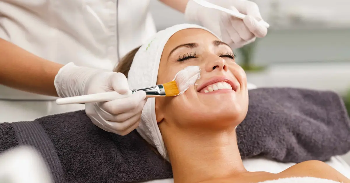 Woman enjoying a relaxing facial treatment in Lisle, IL with a mask applied by an professional