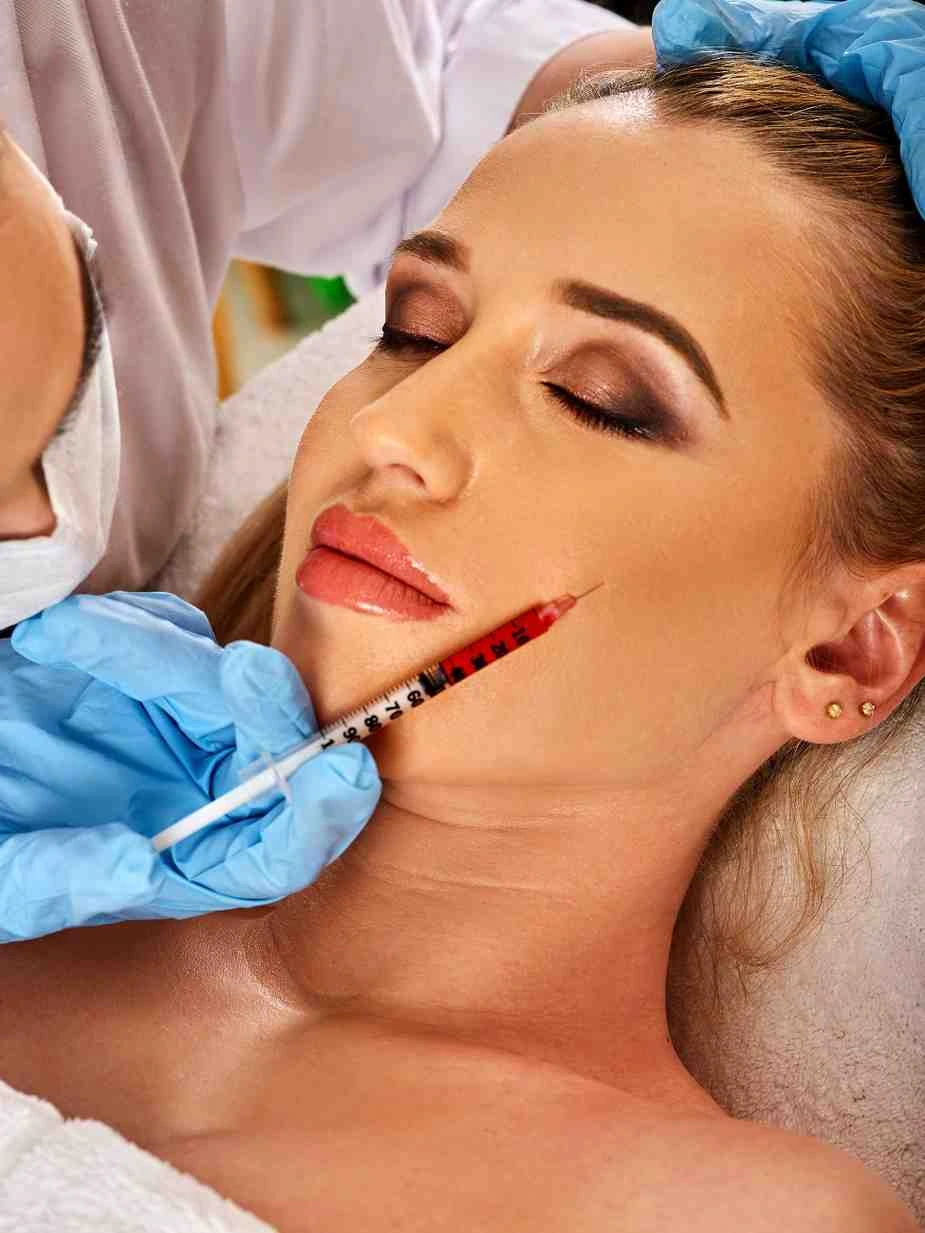Woman receiving dermal fillers for cheek augmentation in Lisle, IL